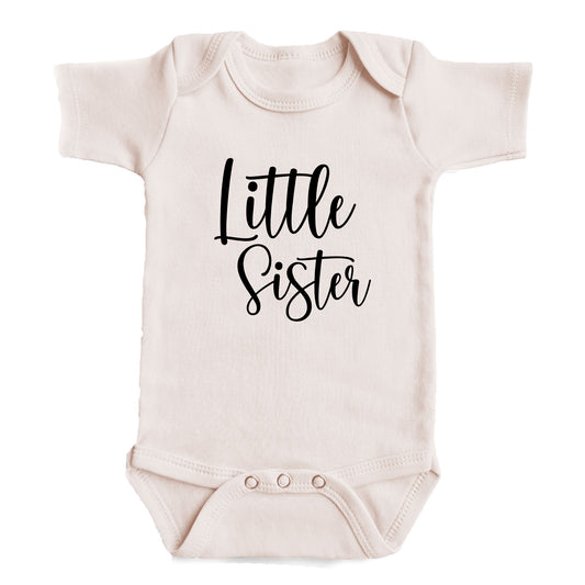 A baby onesie with the text "Little Sister" printed on it.