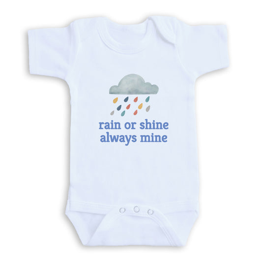 A white baby onesie with a graphic of a cloud and raindrops, along with the text "rain or shine always mine" printed on it.