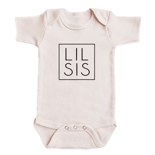 A baby onesie with the text "LIL SIS" printed on it.