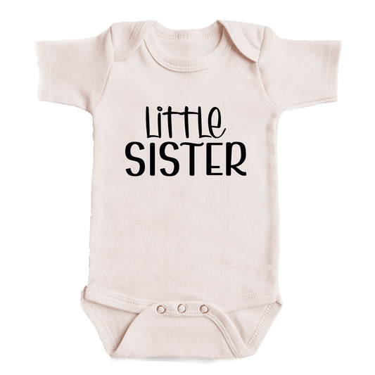 A baby onesie with the text "Little Sister" printed on it.