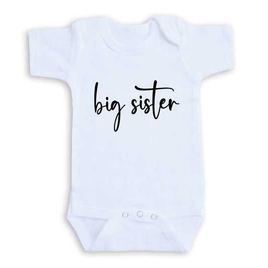 A white baby onesie with the text "big sister" printed on it.