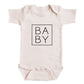 A baby onesie with the word "BABY" printed on it in a square format.