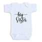 A white baby onesie with the text "big Sister" printed on it.