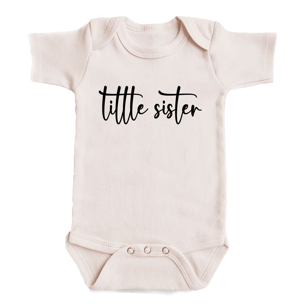 A baby onesie with the text "tittle sister" printed on it.