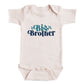 A baby onesie with the text "Big Brother" printed on it.