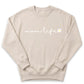 A beige sweatshirt with the text "momm life" printed on it.