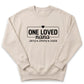 A beige sweatshirt with a black text design that reads "ONE LOVED nana Jerry Jimmy Josie".