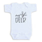 A white baby onesie with the text "my deer" printed on it.