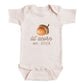A baby onesie with an acorn graphic and the text " lil' acorn est. 2028" printed on it.