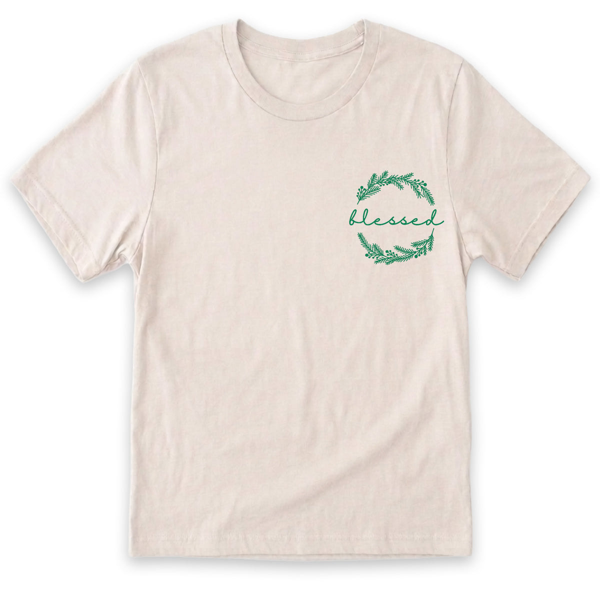 A beige t-shirt with a green wreath design and the word "blessed" written on it.