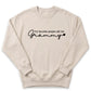 A beige sweatshirt with the text "my favorite people call me Grammy" printed on it.