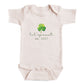A baby onesie with a cloverleaf design and the text "Lil' sprout est. 2027" printed on it.