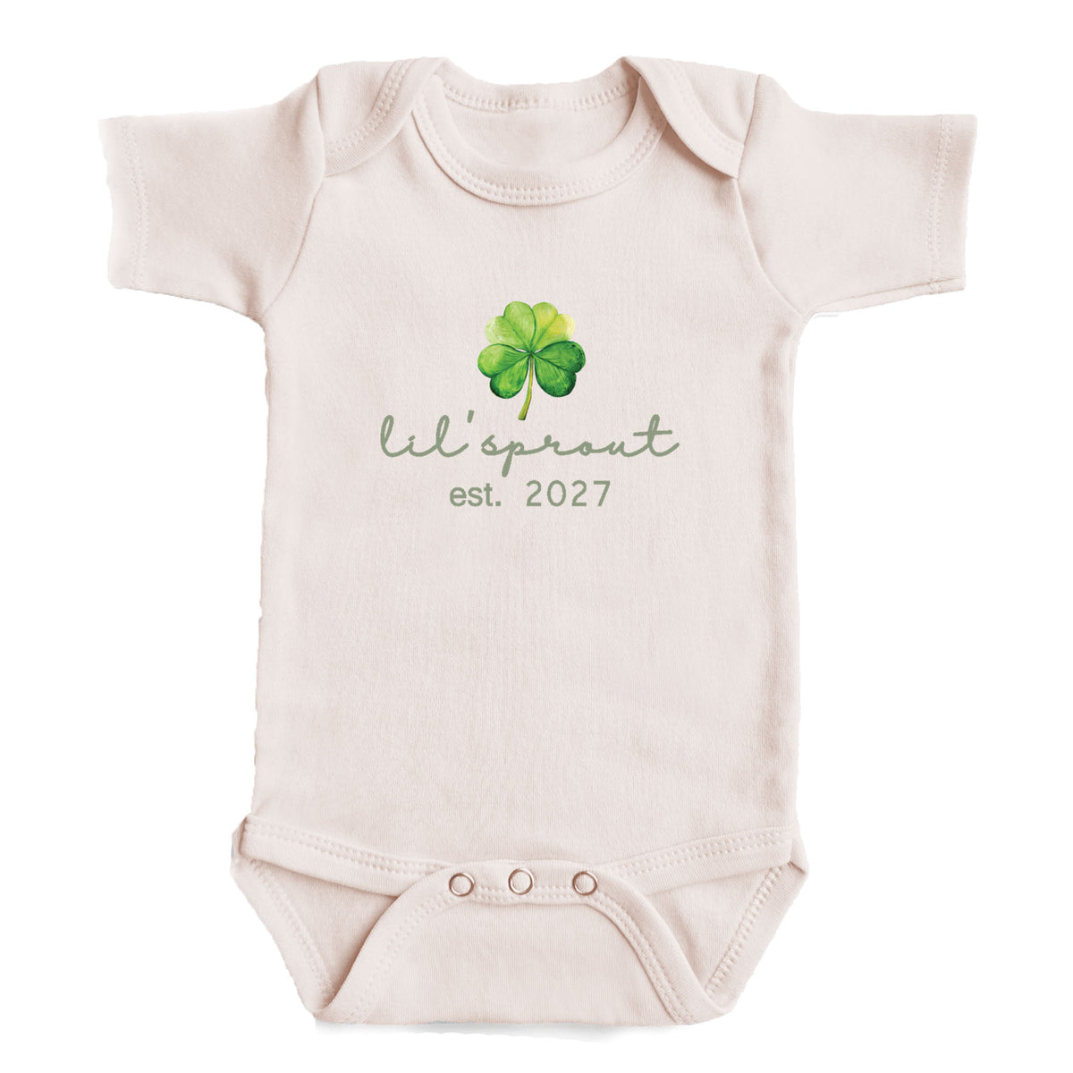 A baby onesie with a cloverleaf design and the text "Lil' sprout est. 2027" printed on it.