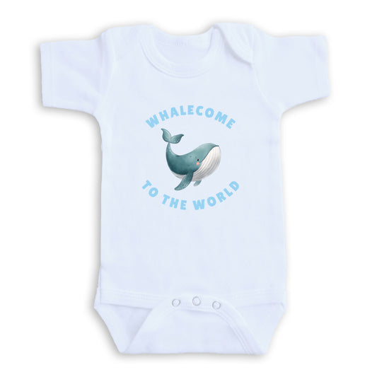 A white baby onesie with a graphic of a whale and the text "Whalecome to the World" printed on it.