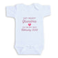 The image is a white baby onesie with text printed on it.