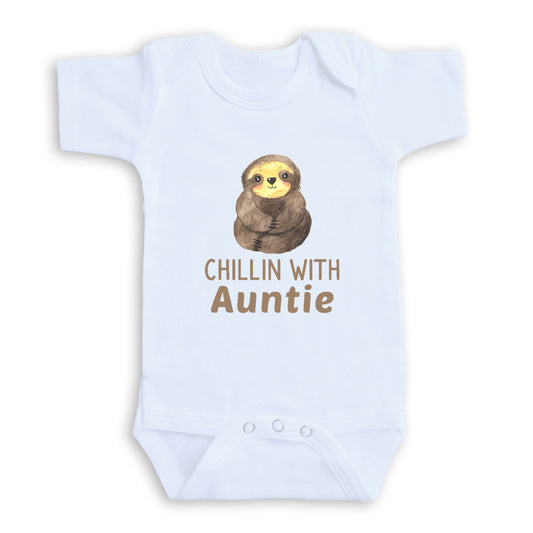 A white baby onesie with a sloth graphic and the text "CHILLIN WITH AUNTIE" printed on it.