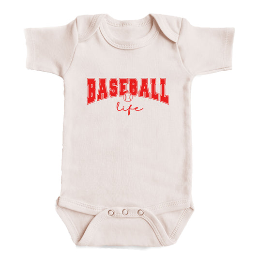 A white baby onesie with the text "BASEBALL life" printed on it in red letters.