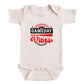 A white baby onesie with a graphic design on it.