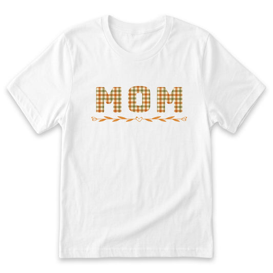 A white t-shirt with the word "MOM" printed on it in a checkered pattern.