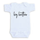A white baby onesie with the text "big brother" printed on it.
