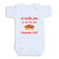 A white baby onesie with a red text and graphic design that reads "a cute pie is on the way November 2027".