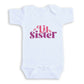 A white baby onesie with the text "Little Sister" printed on it in pink and purple lettering.