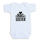 A white baby onesie with the text "BIG SISTER" printed on it.