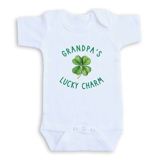 A white baby onesie with a green clover design and the text "GRANDPA'S LUCKY CHARM" printed on it.