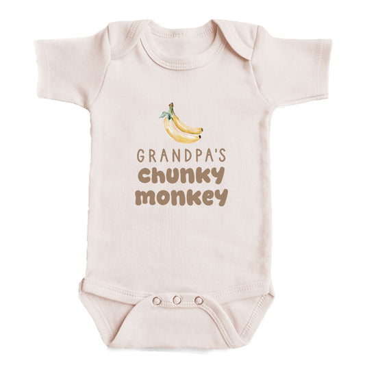 A baby onesie with a printed design of bananas and the text "GRANDPA'S CHUNKY MONKEY" printed on it.