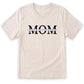 A white t-shirt with the text "MOM" printed on it in a bold, black font.