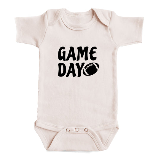 A baby onesie with the text "GAME DAY" printed on it.