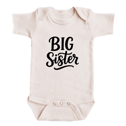 A baby onesie with the text "BIG Sister" printed on it.
