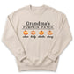 A beige sweater with the text "Grandma's PUMPKIN PATCH" printed on it, along with three orange pumpkins.