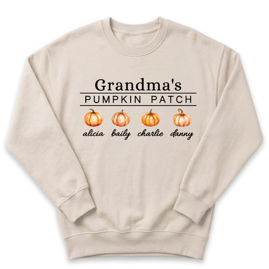 A beige sweater with the text "Grandma's PUMPKIN PATCH" printed on it, along with three orange pumpkins.