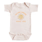 A baby onesie with a sun design and text that reads "Welcome sunshine August 2028".