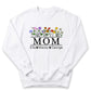A white sweatshirt with a graphic design featuring colorful flowers and the text "MOM" in the center.