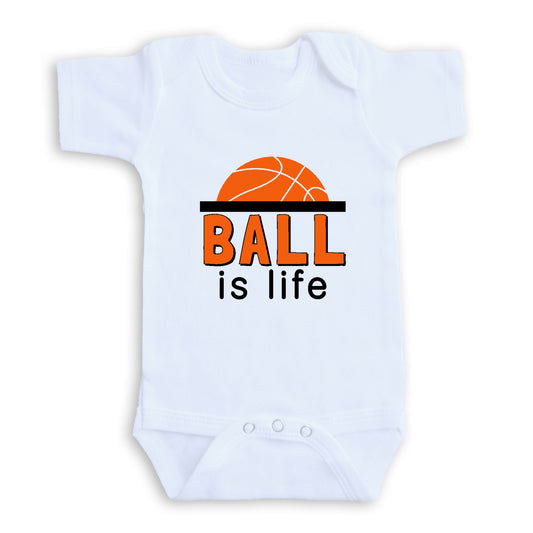 A white baby onesie with the text "BALL is life" printed on it.