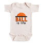 A white baby onesie with the text "BALL is life" printed on it.
