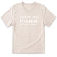 A beige t-shirt with the text "WORLD'S BEST nana" printed on it in white lettering.