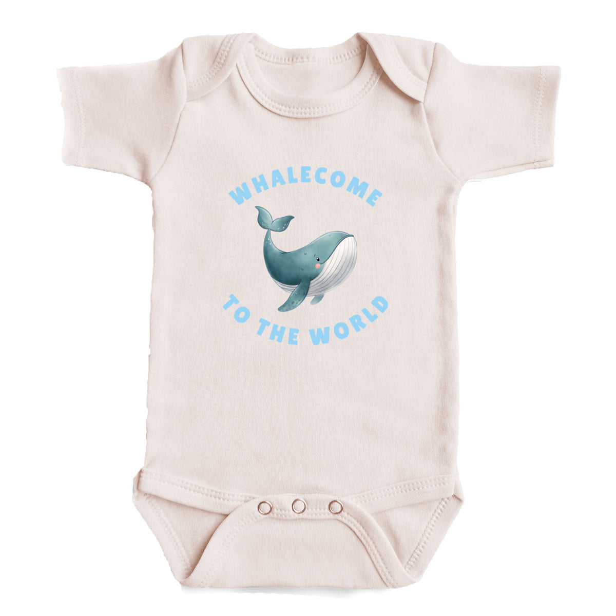 A baby onesie with a printed design of a whale and the text "Whalecome to the world" on it.