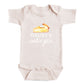 A baby onesie with a printed design of a slice of pie and the text "DADDY'S CUTIE PIE" printed on it.