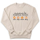 A beige sweatshirt with a graphic design featuring three pumpkins and the text "mini's PUMPKIN PATCH alicia bailey charlie dany".