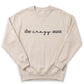 A beige sweatshirt with the text "the crazy aunt" printed on it.