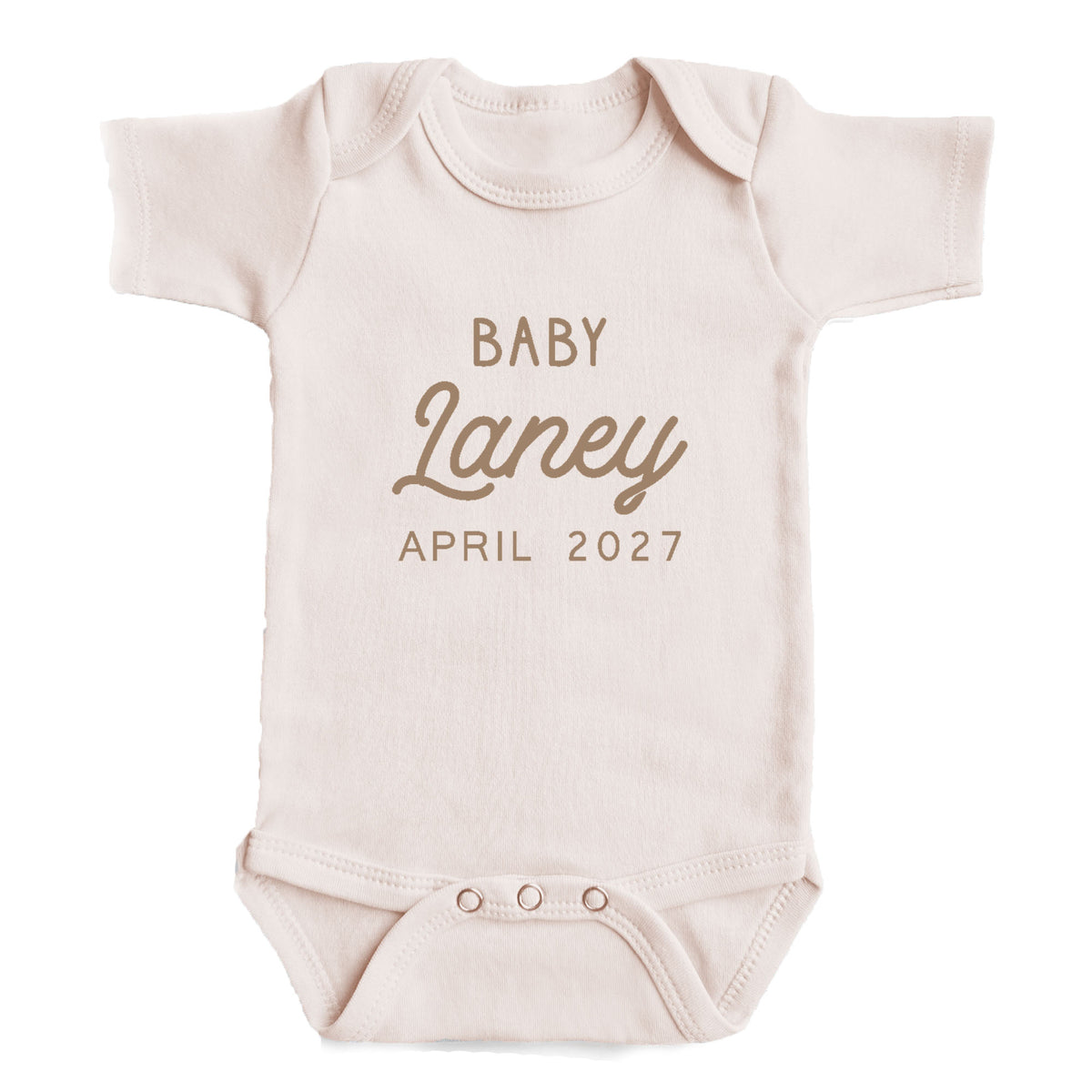 A baby onesie with the text "BABY Laney April 2027" printed on it.