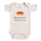 A baby onesie with a printed image of a pie and the text "Grandma's SWEETIE PIE" printed on it.