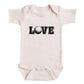 A baby onesie with the word "LOVE" printed on it.