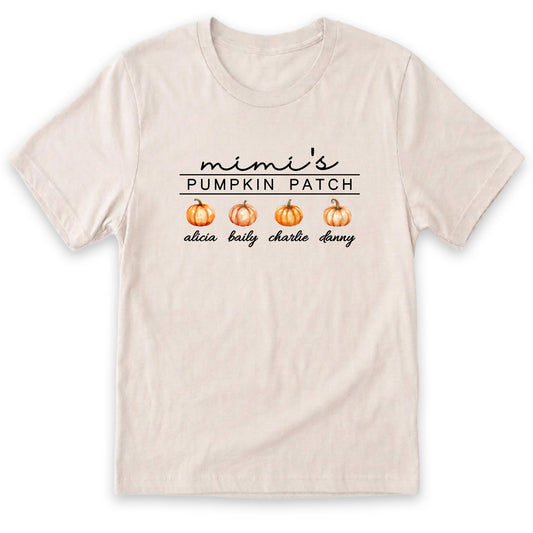 A beige t-shirt with a graphic design featuring three pumpkins and the text "mini's PUMPKIN PATCH alicia bally charl dany".
