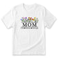 A white t-shirt with a graphic design featuring a row of colorful flowers and the text "MOM" below them.