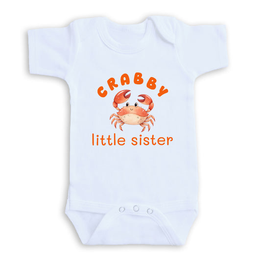 A white baby onesie with an orange crab design and the text "CRABBY little sister" printed on it.