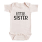 A baby onesie with the text "Little Sister" printed on it.